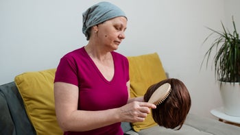 Low-cost free healthcare: cancer patient brushing wig 1395201903