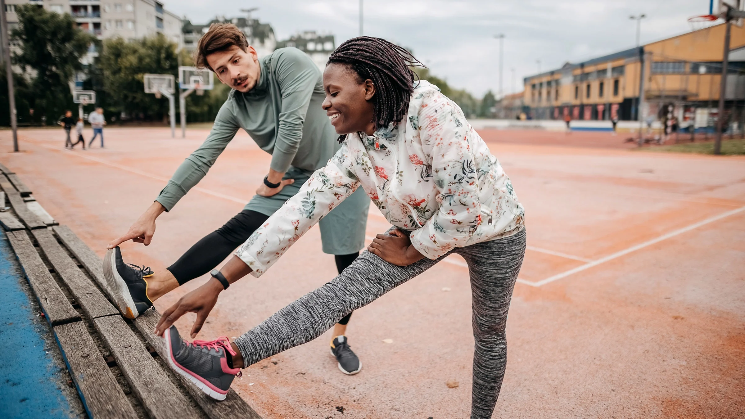 A person stretching in a park.