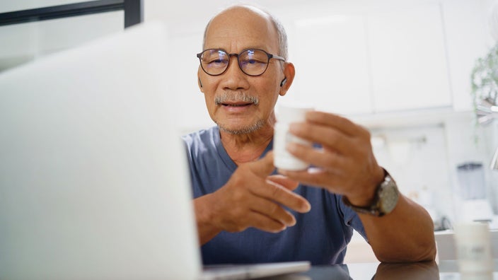 Senior man having video consult with a doctor online