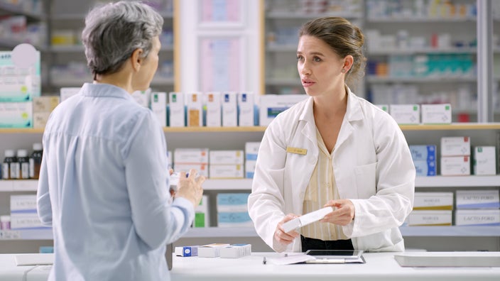 Woman speaking to a pharmacist.