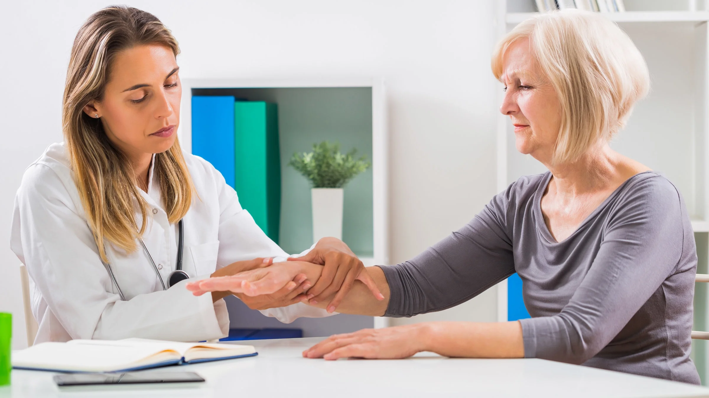 A doctor examining a patient's wrist.