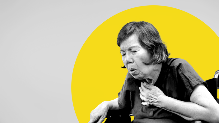 Black and white image of an older woman in a wheelchair coughing and holding her chest. There is an added yellow graphic circle behind her on the gray background.