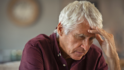 A man with his hand on head looks tired while sitting at home.
Ridofranz/iStock via Getty Images Plus