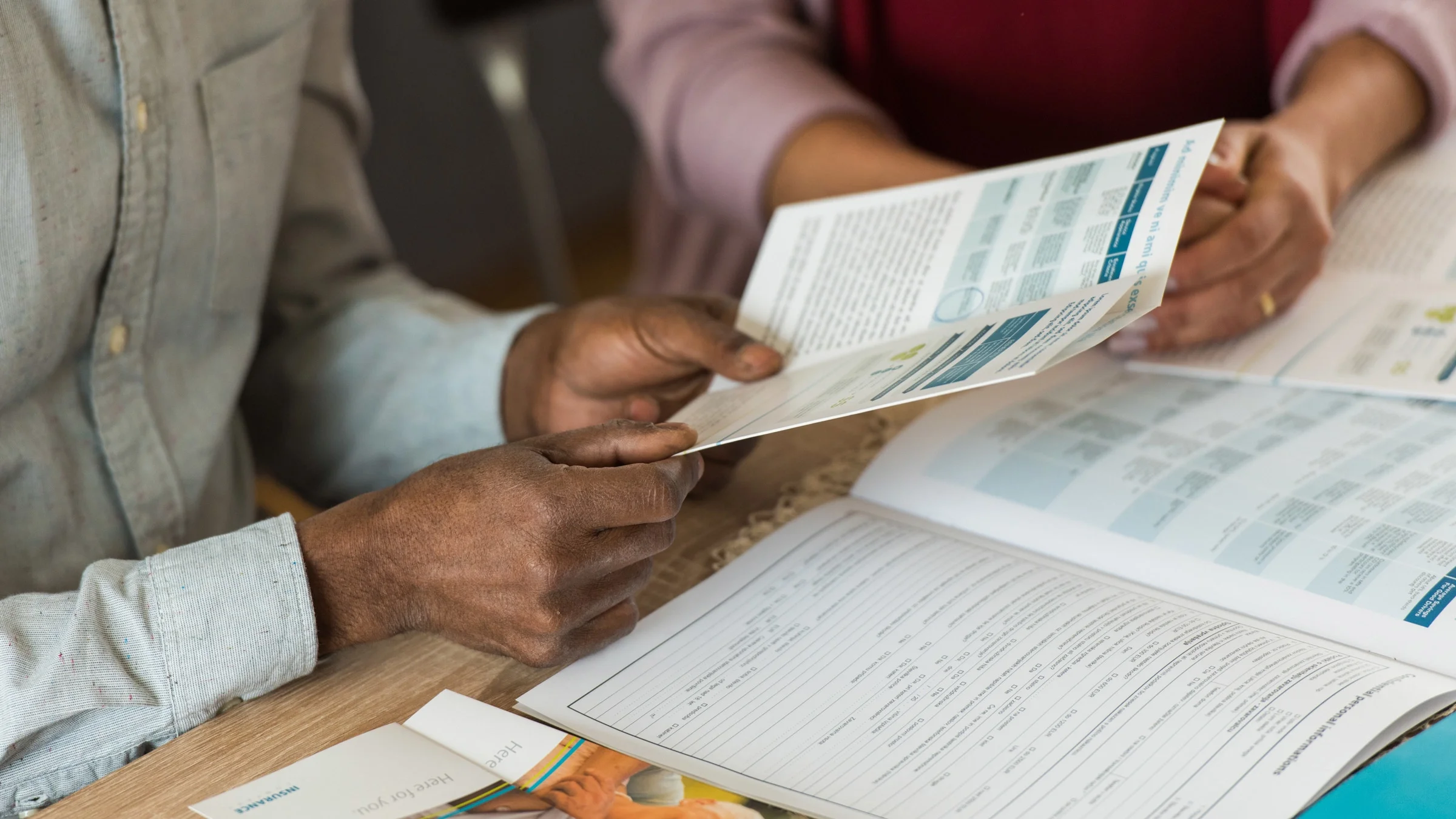 A couple looking at a brochure.