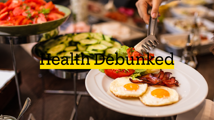 Cropped shot of a person at a breakfast buffet eating healthy foods. There is added text on top reading “Health Debunked” with a yellow highlight bar behind it.