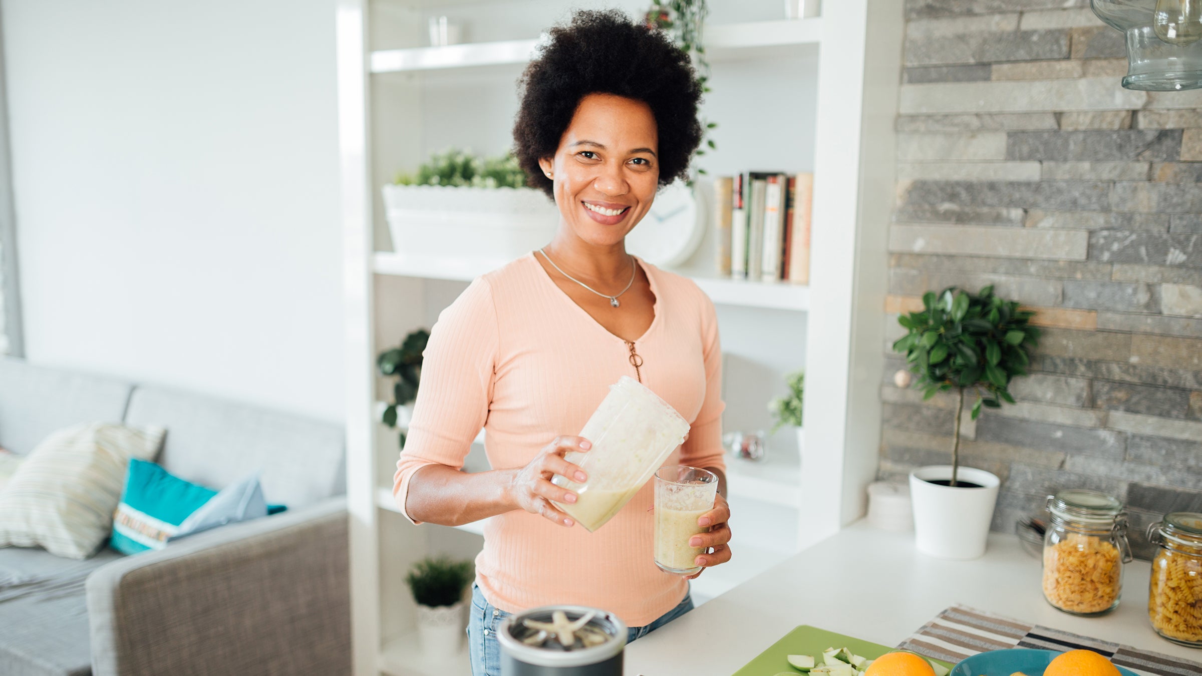 Diet nutrition: Vitamin A: woman pouring smoothie-1277415360