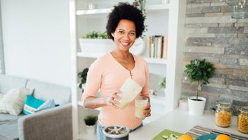 Diet nutrition: Vitamin A: woman pouring smoothie-1277415360