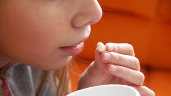Health: Trikafta: closeup girl taking pill 1292278050