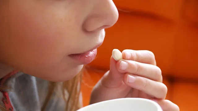 Health: Trikafta: closeup girl taking pill 1292278050