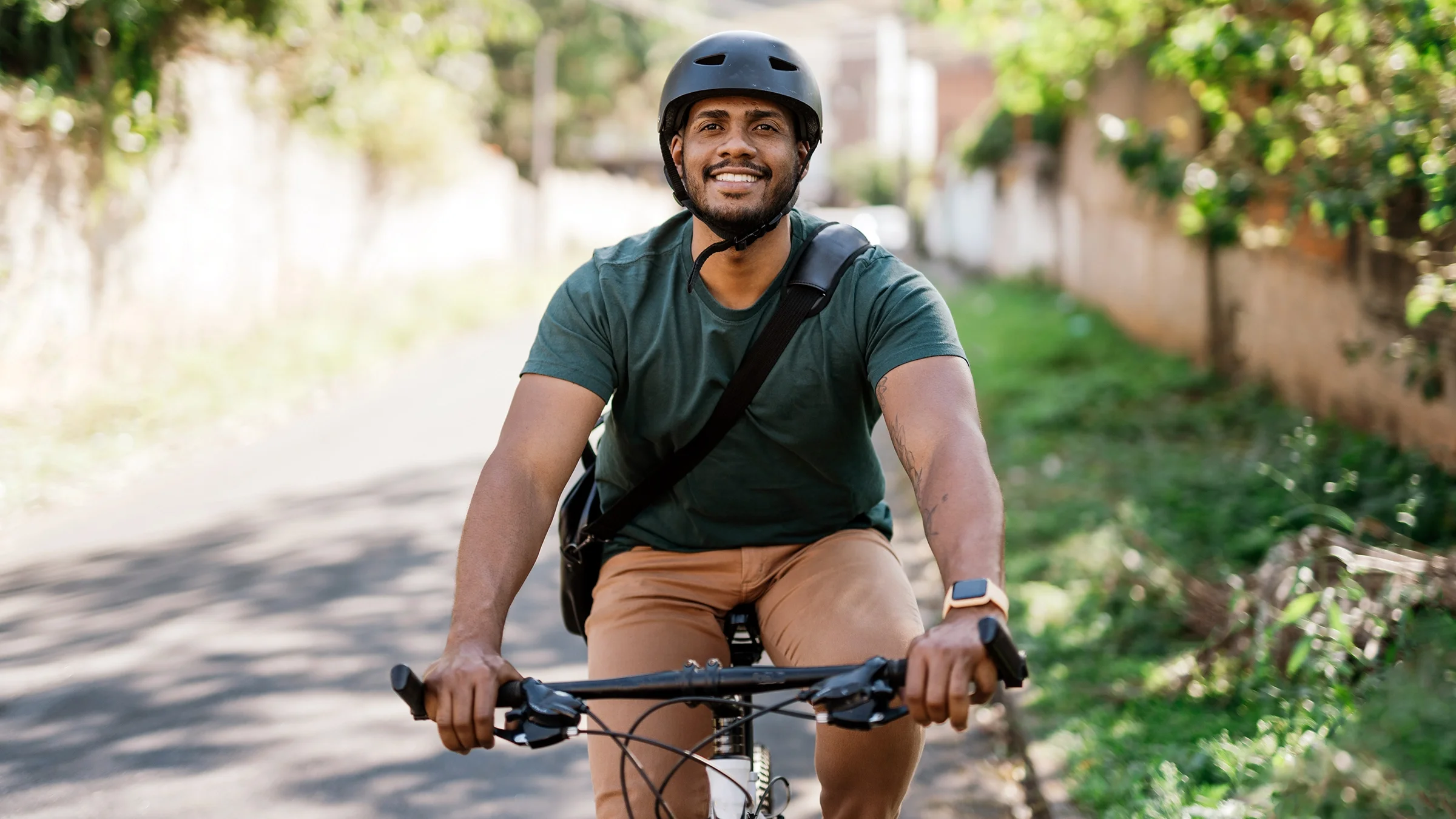 Man smiling while riding a bicycle.