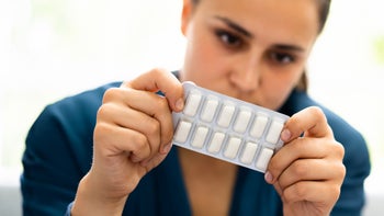 Nicotine: woman holding pack of nicotine gum 1326732735