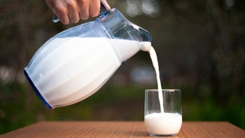 diet-nutrition: closeup hand pouring milk 1148027170
