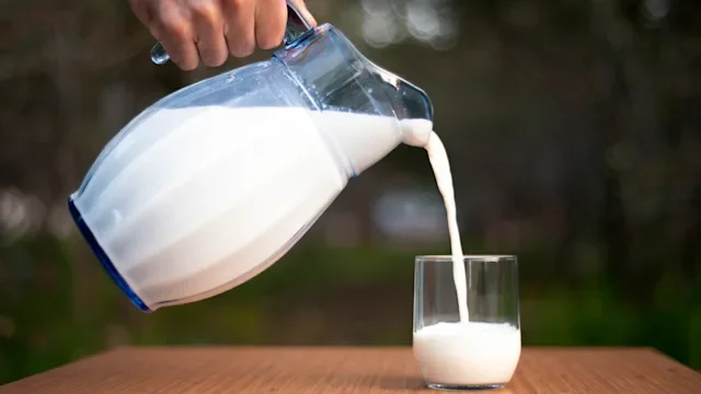 diet-nutrition: closeup hand pouring milk 1148027170
