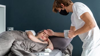 Respiratory: masked person taking care of sick person 1287241365