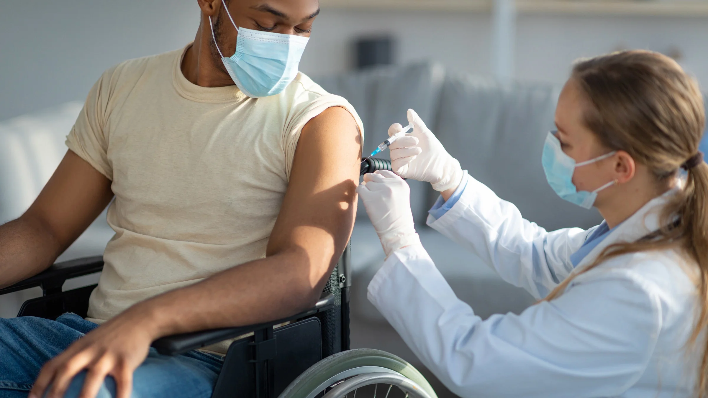 A wheelchair user getting a vaccine.