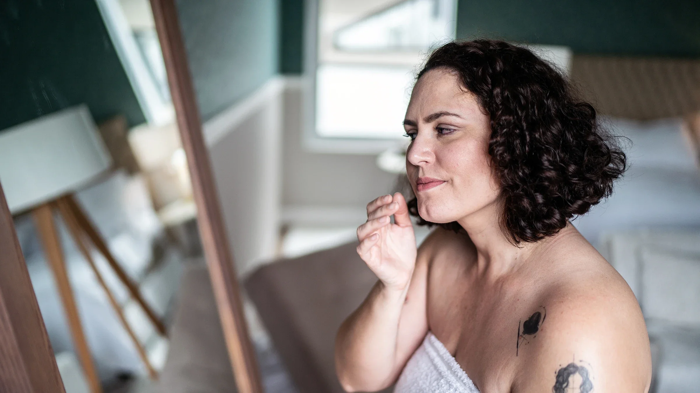 A woman applies face cream following a shower.
FG Trade/E+ via Getty Images