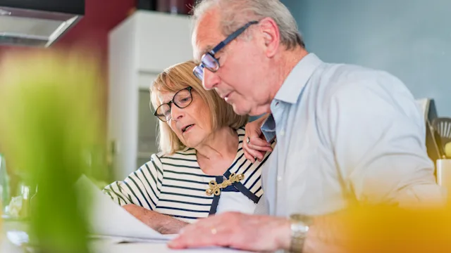 Medicare: senior couple reviewing paperwork 537290888