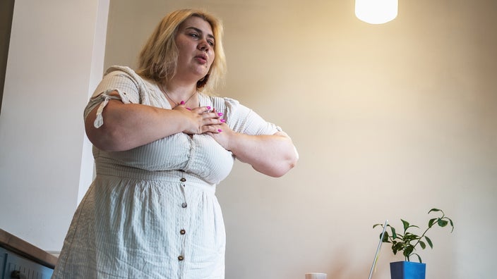A woman experiences heartburn. Heartburn is one of the side effects of Ozempic, a medication used to treat Type 2 diabetes. 