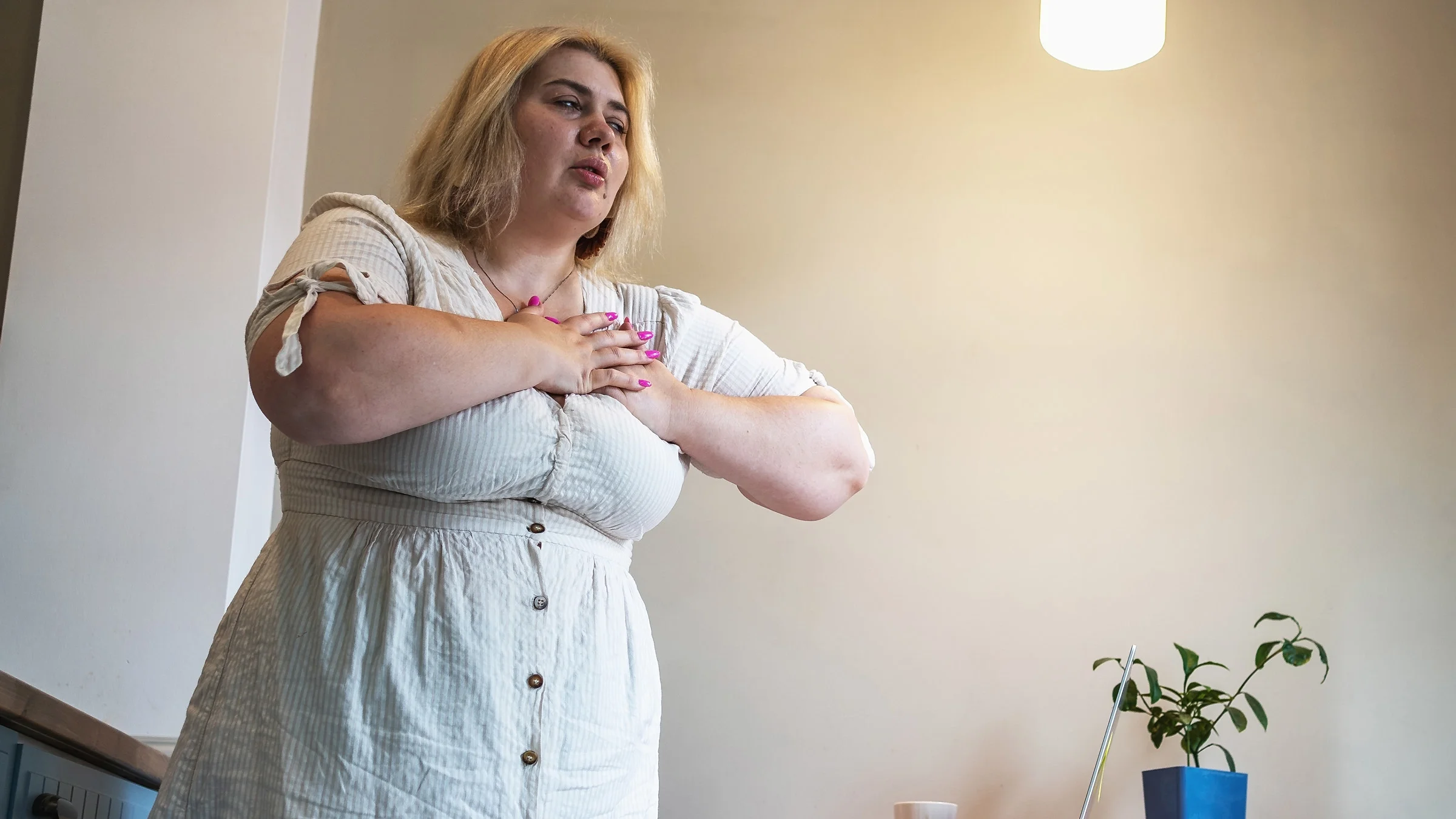 A woman experiences heartburn. Heartburn is one of the side effects of Ozempic, a medication used to treat Type 2 diabetes.