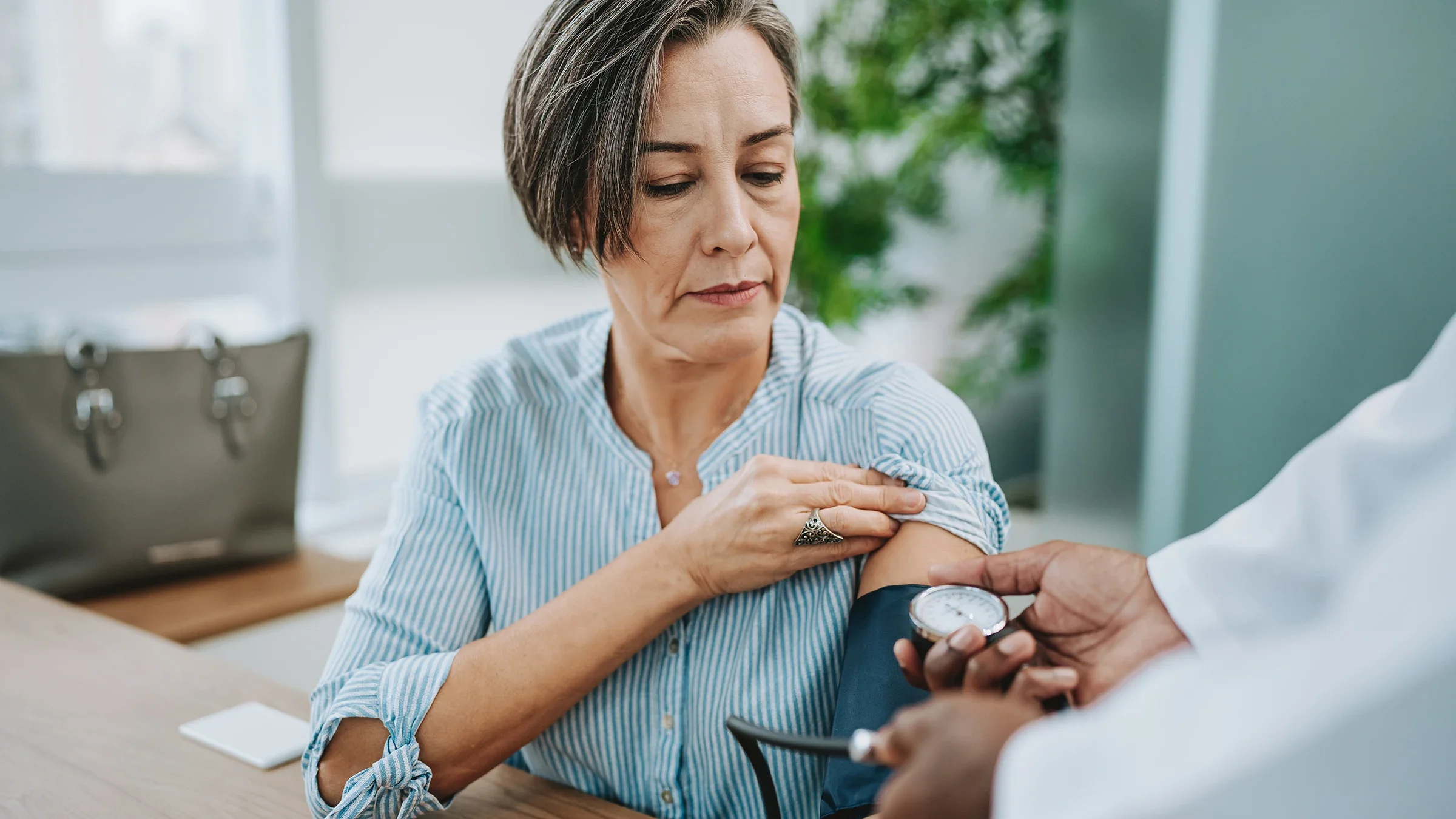 A woman gets her blood pressure measured by a healthcare professional. 
andreswd/E+ via Getty Images