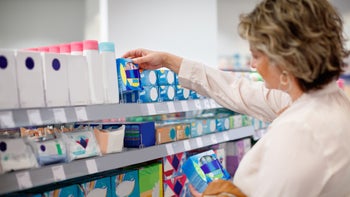 Health-Insurance: woman buying menstrual products 1383838210