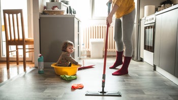 Children's health: Lead poisoning: child watching parent mop 1181306229
