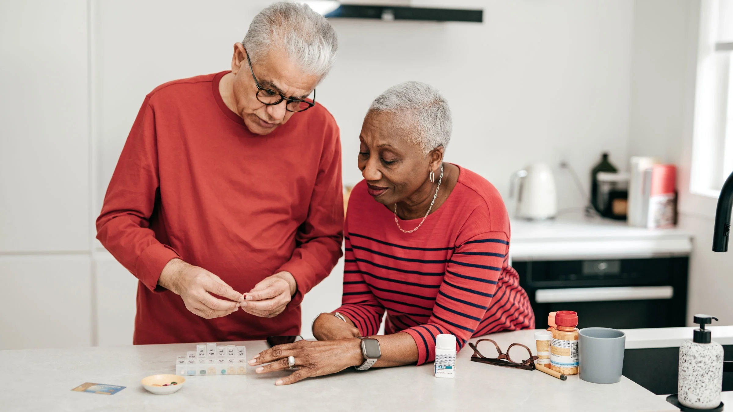 Senior couple sorting through weekly medication
