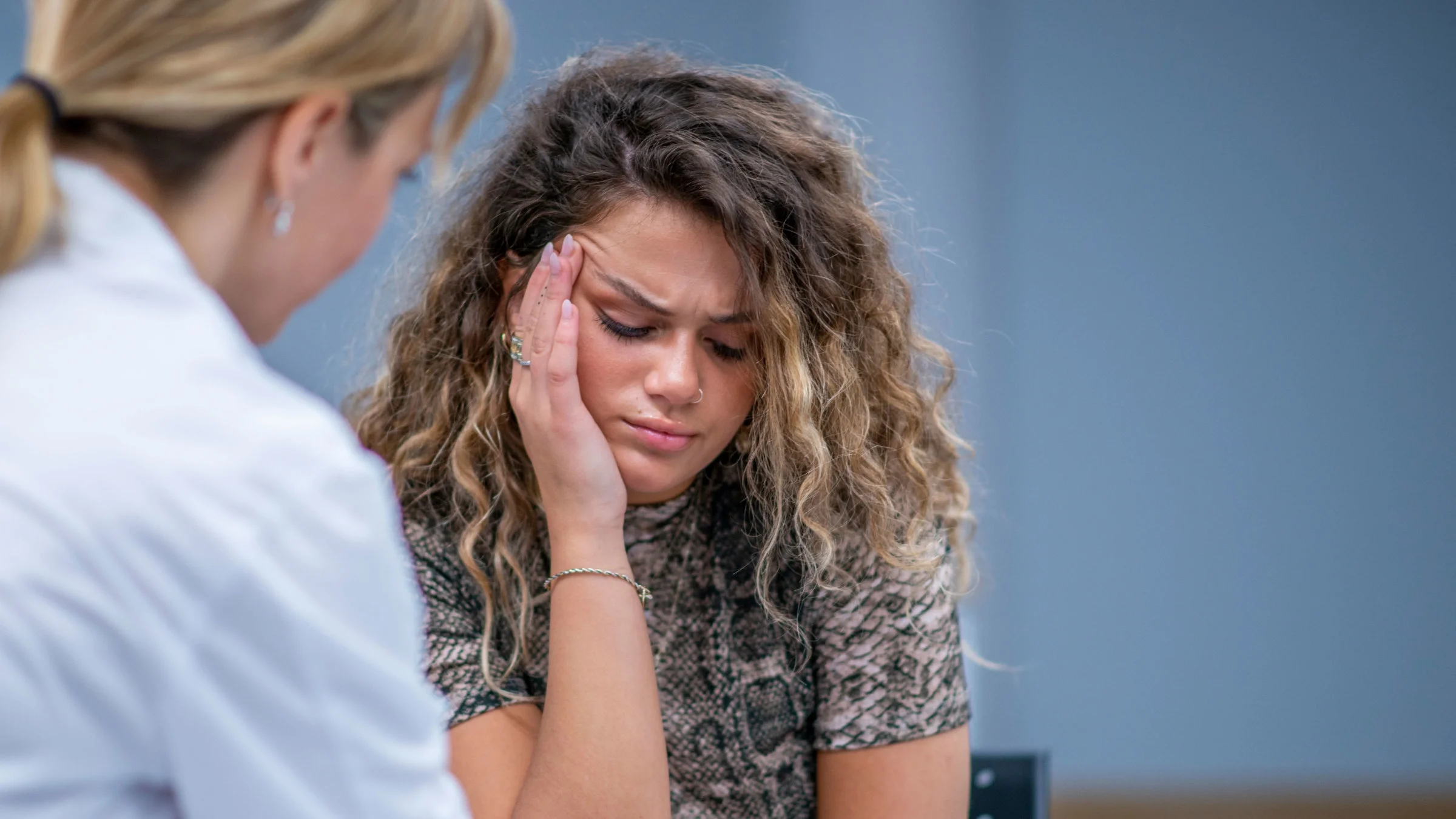 Woman looking distressed while talking to therapist.