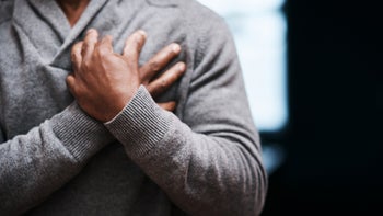 Health: Sickle cell disease: close-up man clutching chest 1135050296