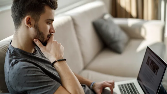 Research: Medical misinformation: reading article on laptop-1086607096