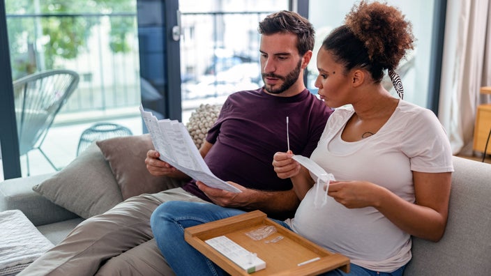 A couple read instructions for an at-home COVID-19 test. Expired COVID tests may give you inaccurate results.