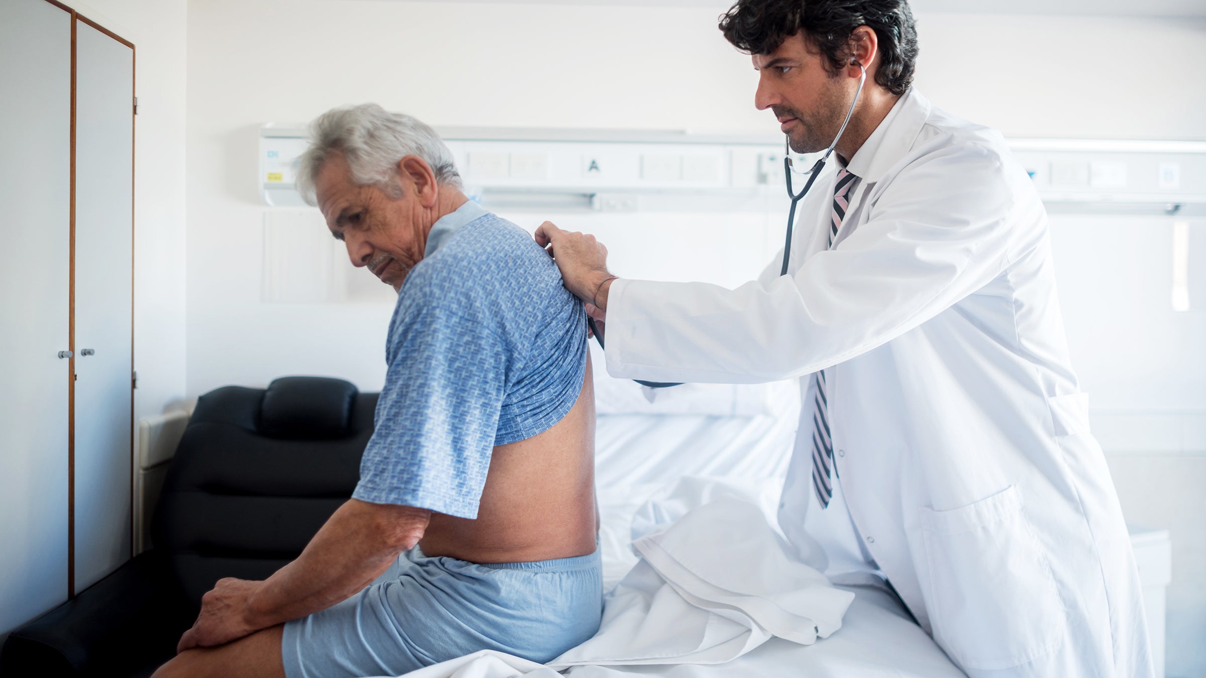 Health: Renal cancer: doctor examines back of senior patient 912333788