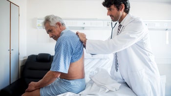 Health: Renal cancer: doctor examines back of senior patient 912333788
