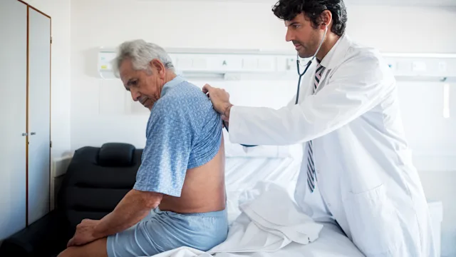 Health: Renal cancer: doctor examines back of senior patient 912333788