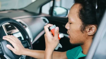 Symbicort: man using inhaler in his car 1805942903