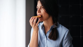 Nausea: woman eating toast 1029320030