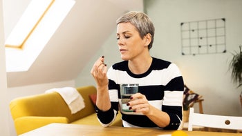 Health: Olumiant: woman taking pill with water 1452664208