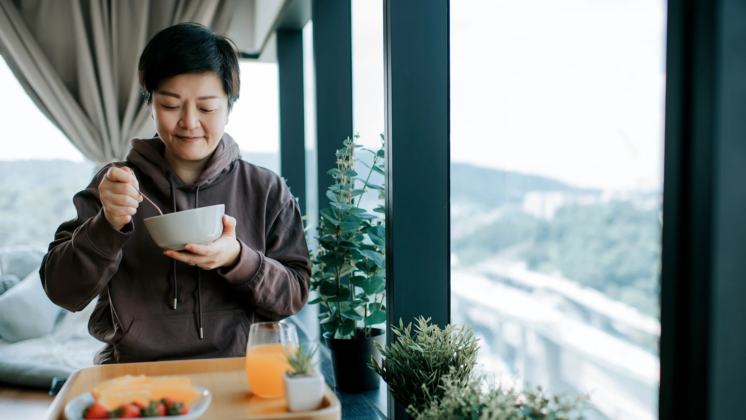 Woman enjoying her breakfast at home.