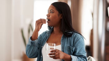 Supplement Herbs: woman taking medication at home 1322388438