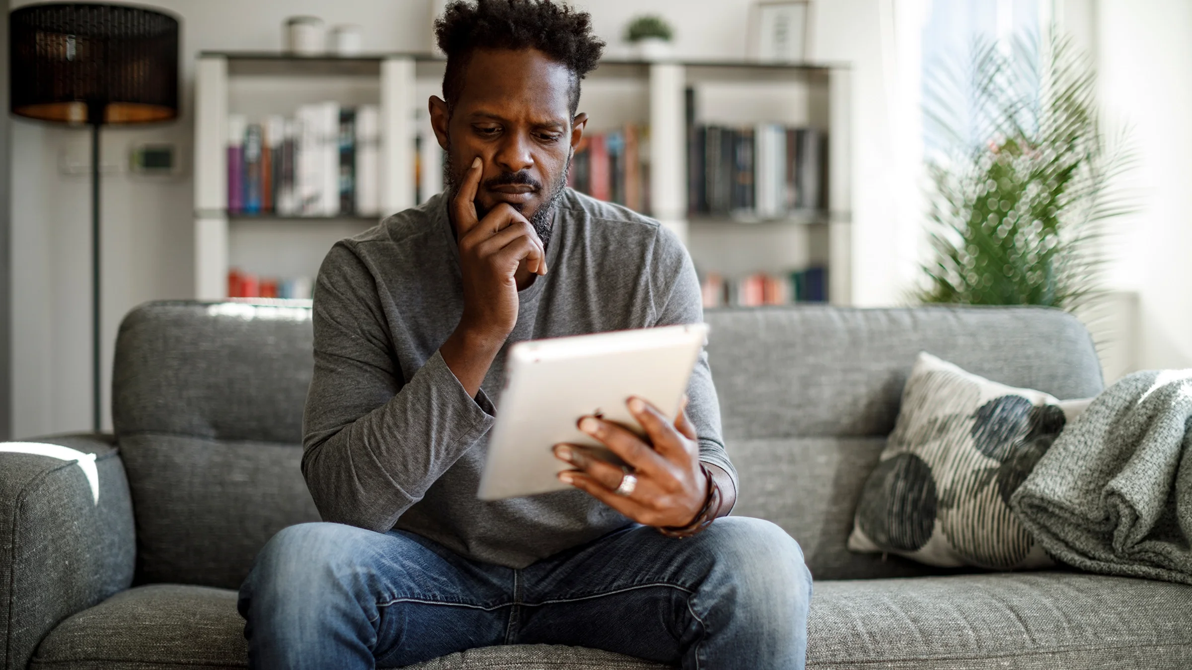 Man reading a digital tablet.