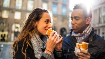 Health: Diet and nutrition: couple snacking outdoors 473932788