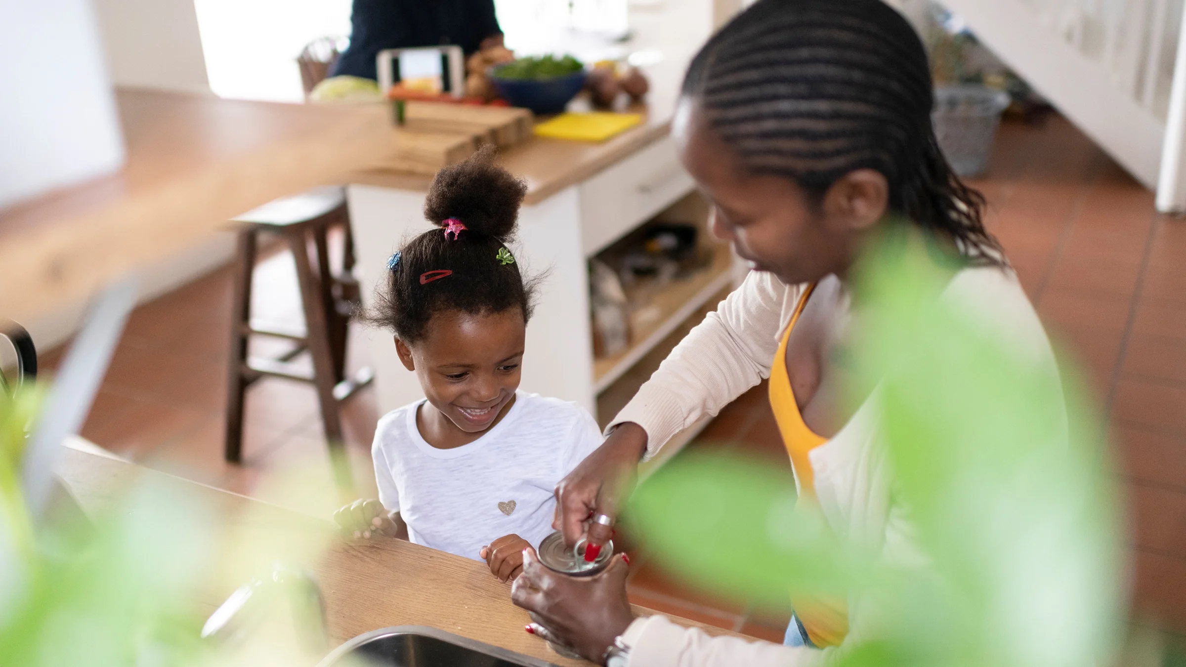 Parent opening a canned good.
