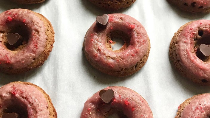 A tray of sugar- and grain-free donuts with a pink glaze and chocolate hearts, made in Jessica Stern-Enzi’s bakery.