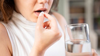 Yeast infection: woman taking pill 1317750723