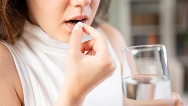Yeast infection: woman taking pill 1317750723