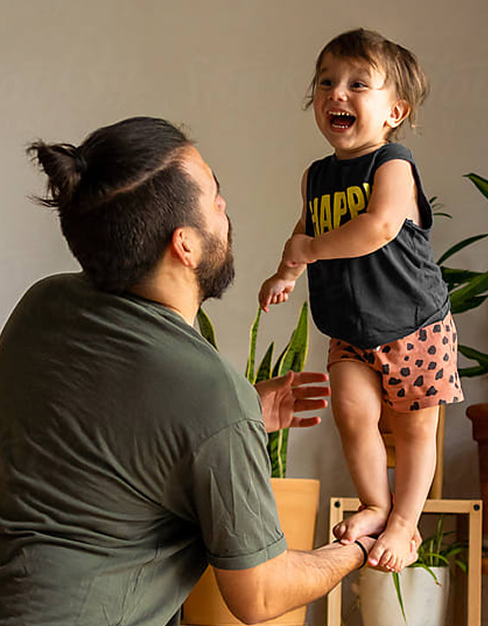 Father playing with his smiling son at home