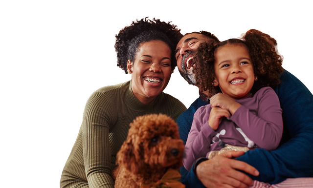Smiling family with a dog